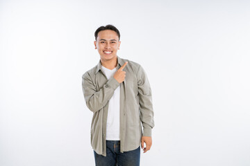 Fototapeta premium A cheerful young man gestures energetically, showcasing his positivity and enthusiasm