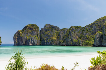 Maya Bay, a beautiful beach with turquoise water in a lagoon under a sunny day with clear sky and cloud, a very popular destination in Phi Phi Islands, Phang-nga province, Southern of Thailand