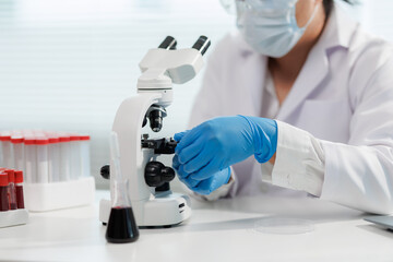 Scientist mixing chemicals in a lab experiment.