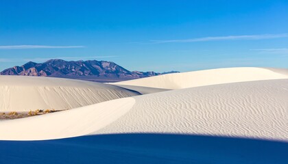 Wide-angle desert landscape.  Vast white sand dunes under clear blue sky