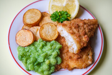 Breaded Cod Fillet With Fried Saute New Potatoes And Mushy Peas