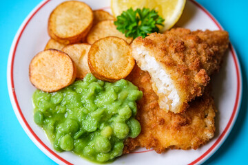Breaded Cod Fillet With Fried Saute New Potatoes And Mushy Peas
