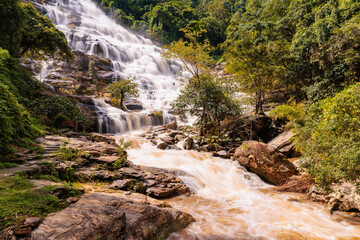 Landscape nature Mae Ya waterfall located in Doi Inthanon National Park. A popular destination for tourist in Chiangmai province, Northern of Thailand. The wooden sign is waterfall name