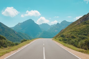 Fototapeta premium Scenic Mountain Road with Clear Blue Sky and Lush Green Landscape