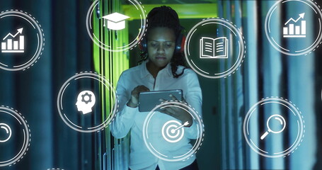 Tech professional woman tapping tablet in server rack corridor, showing floating analytics icons