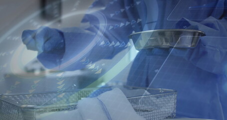 Nurse in blue scrubs transferring from mesh basket onto tray at prep table, with interface overlay