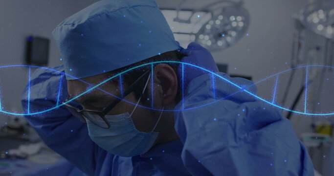 Male surgeon adjusting cap straps in operating room, with surgical mask and DNA helix overlay