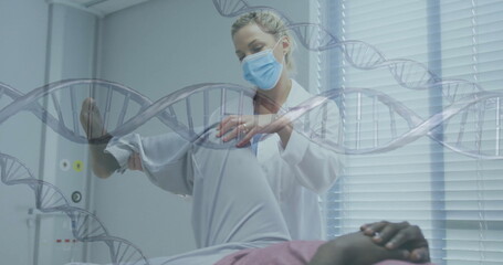 Woman doctor in lab coat and mask lifting patient leg in examination room, with DNA overlay