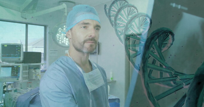 Studying surgeon in blue scrubs cap in operating room with monitors and floating DNA helix