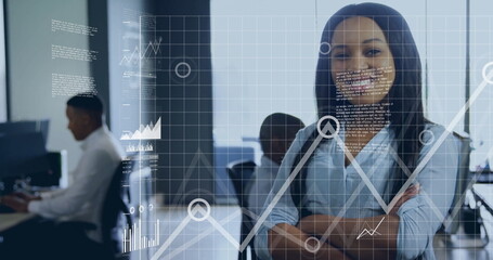 Standing woman crossing arms, smiling at camera in office with monitors, data overlays, copy space