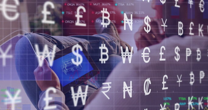 Reclining Asian man analyzing schematic on tablet in lounge, with floating currency symbols