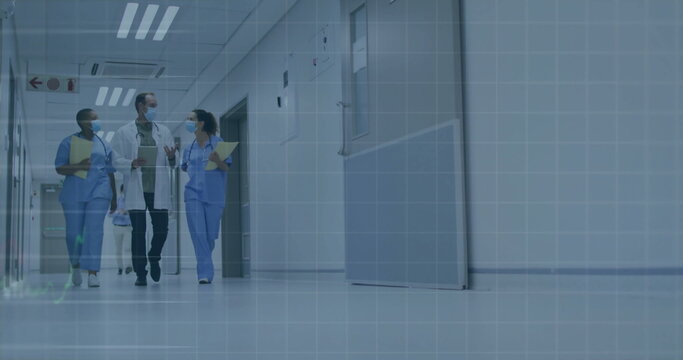 Walking masked staff carrying stethoscope tablet folder clipboard in hospital hallway, copy space - Powered by Adobe