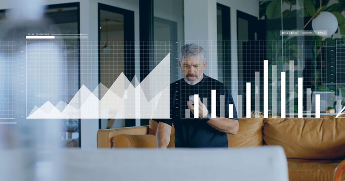 Viewing holographic charts senior man holding smartphone in modern living area, with leather sofa - Powered by Adobe