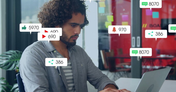 Working curly-haired man typing on laptop in modern office, with notification icons, copy space