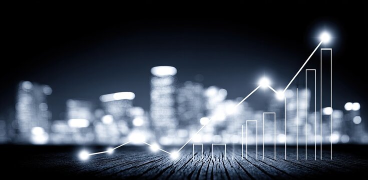 A night city skyline, overlaid with a graphic of rising bar graph data, situated on a wooden surface