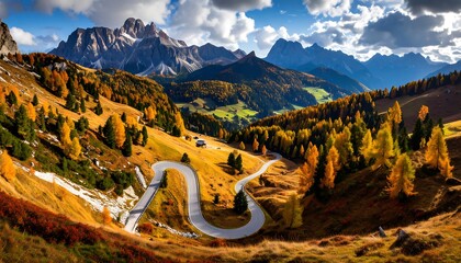 A winding mountain road snakes through a vibrant autumn landscape, showcasing colorful trees and majestic peaks.