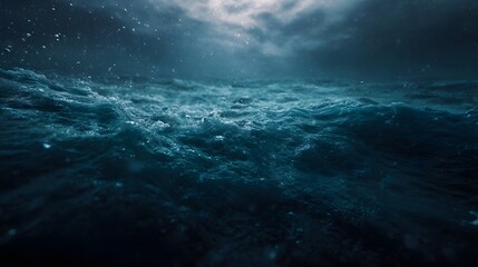 Obraz premium An immersive deep sea perspective showing the turbulent surface of the ocean from below with shafts of light penetrating the dark blue water