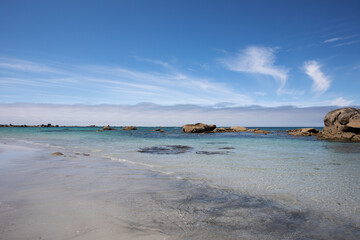Summer day at Plage du Vougot, Guissény, Les Abers, France. Scenic Atlantic coast beach with golden sand, turquoise sea, and clear blue sky in a peaceful seaside landscape.