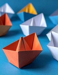 Vivid origami paper boats of various colors stand out against a deep blue backdrop, showcasing a collection of different perspectives.