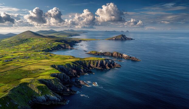 Panoramic coastal view of Ireland's rugged coastline, with rolling hills, green pastures, and dramatic cliffs meeting the azure ocean.  Large, fluffy clouds are scattered across a vibrant blue sky