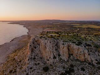 Rocky Cliffs and Turquoise Mediterranean Waters in Cyprus at Sunset