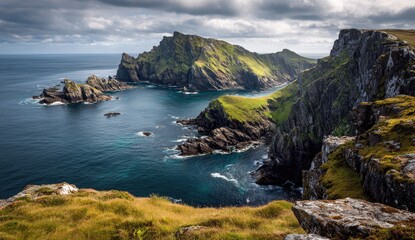 Fototapeta premium Dramatic coastal scenery with rugged cliffs, lush green hills, and a turquoise-tinged ocean