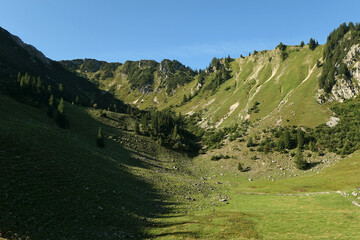 Morning shadow on a high plateau, surrounded by a ridge, pastureland