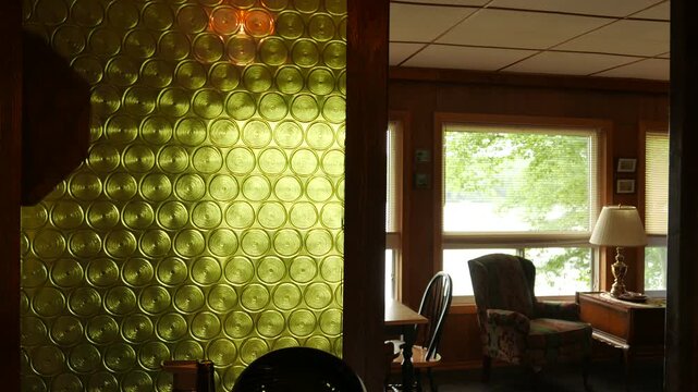Interior of a classic 1970's style house. Vintage decor with minimal movement of trees blowing in the wind through the window.