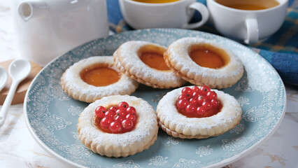 Pastries with citrus jam decorated with currants - closeup