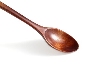 There is a wooden brown spoon on a white background.	