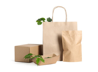 Different eco friendly packaging and leaves isolated on white
