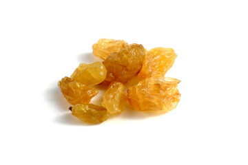 There is a pile of yellow raisins on a white background.	