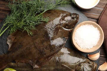 Fresh flounder fish, salt and products on wooden table, flat lay. Raw seafood
