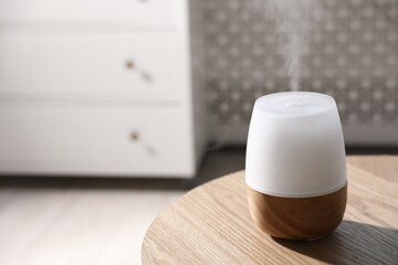 One stylish aroma lamp on wooden table indoors, closeup. Space for text