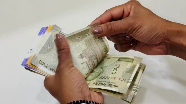 Money counting in bank on isolated background, an india currency rupee notes, 500, 100, and 200 notes.