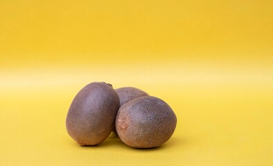 Kiwi Fruit Isolated on Yellow Background with Copy Space