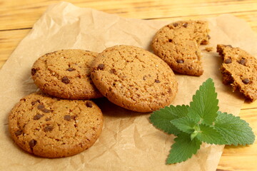 There are oatmeal cookies on the wooden table.	