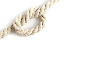 A twisting rope lies on a white background.	