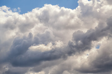 Sunlight inside white cumulus cloud with pronounced texture close-up.