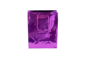 Purple shiny packaging bag stands on white background.	