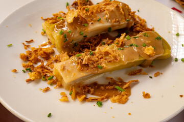 Three onions vegetarian dish, oven baked leek, dried onion and green onion served in French restaurant bouillon in Toulouse, healthy food