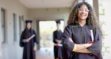 Teen graduate standing on campus path starting green molecules spreading across gown for graduation