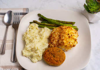  baked cod with crab cakes  and mashed potatoes