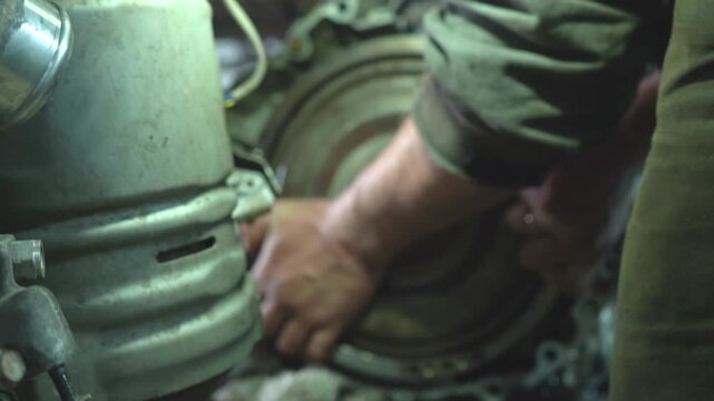 Auto mechanic assembles gearbox. Car gearbox repair in auto repair shop.