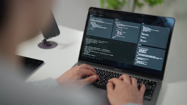 Close-up of Hands Typing Code on Laptop Keyboard, Highlighting Remote Work and Software Development