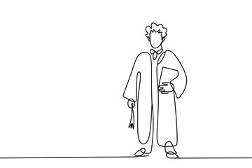 Graduate in cap and gown holding a book