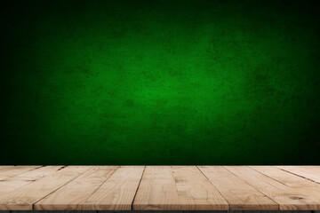 Empty table and darkgreen wall. Table with sun reflections and leaves shadows on beige wall. Background with bokeh for product presentation.Mock up for presentation, branding products, cosmetics food 