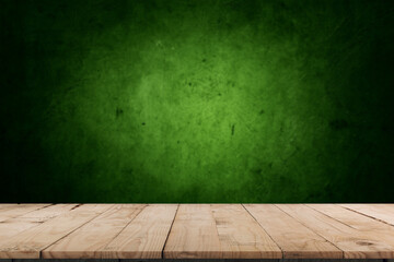 Empty table and darkgreen wall. Table with sun reflections and leaves shadows on beige wall. Background with bokeh for product presentation.Mock up for presentation, branding products, cosmetics food 