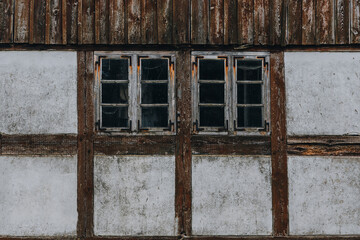 Weathered timber-frame windows on rustic wall