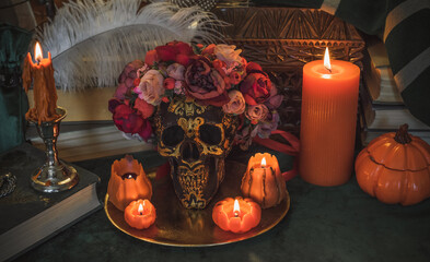 Orange candle on a vintage table, dark academia aesthetic. Evening October time
